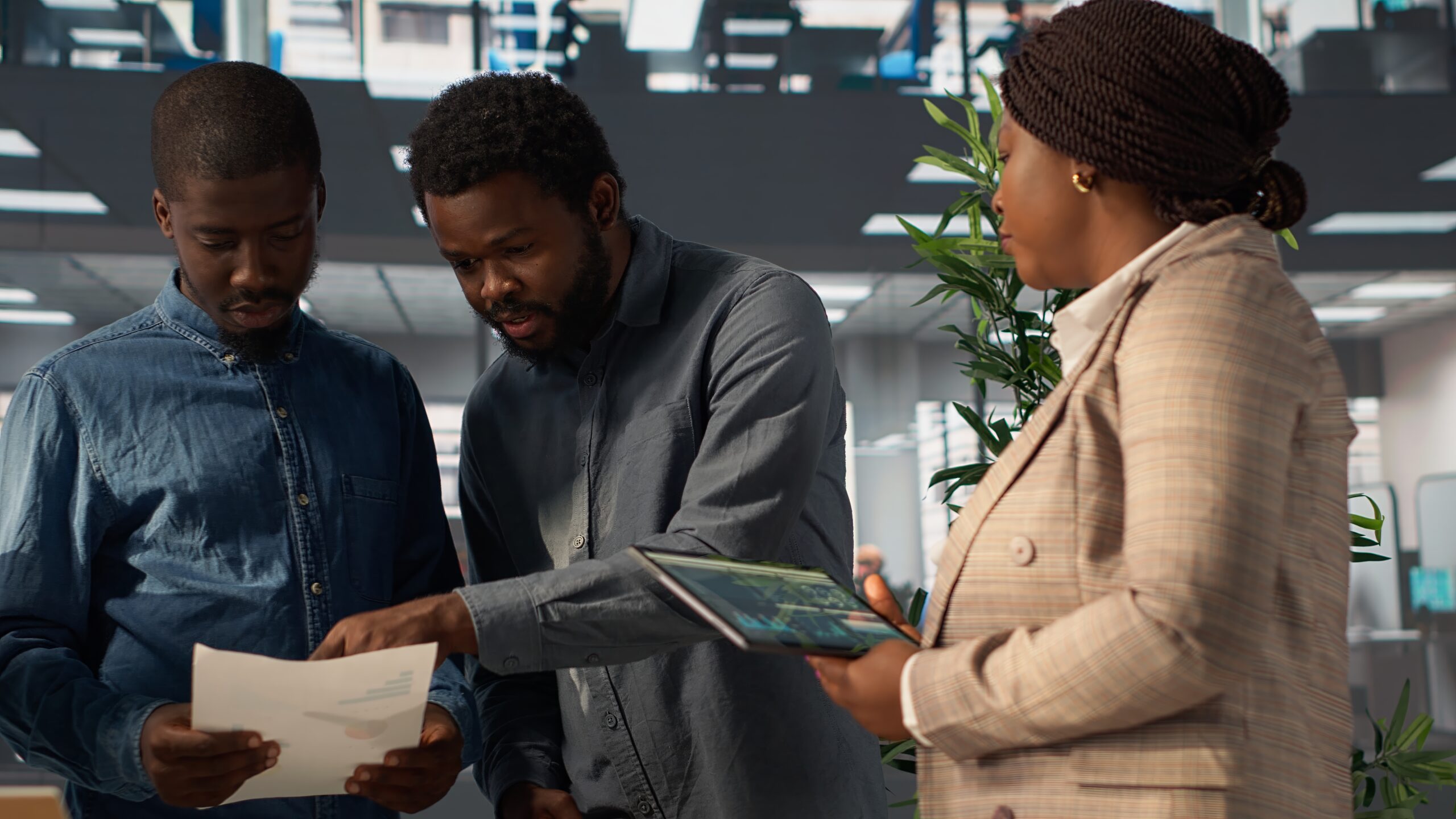 Professional team analyzing archived data on a financial file during meeting, collaborating on enterprise solutions and solving tasks to improve performance for long term growth. Camera A.