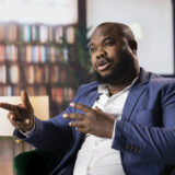 Confident entrepreneur strategize his business over whiskey in a luxury social club, representing diversity and the sophisticated old money fortune. Businessmen negotiating for a collaboration.