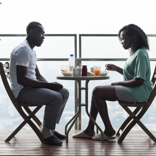 Couple having breakfast together at the balcony